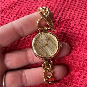 Burberry Women's Gold Chain Watch got your normal ware light scratches.